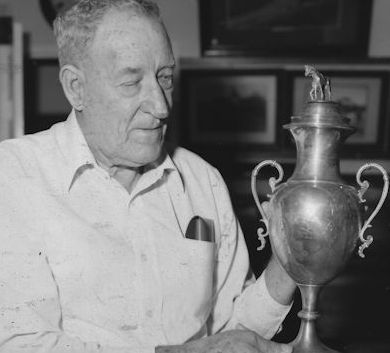 Frank Stewart holds a trophy which is on display at the Central Queensland Racing Hall of Fame and Museum.