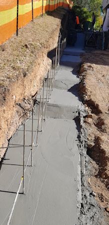 Pouring the footings for the retaining wall.